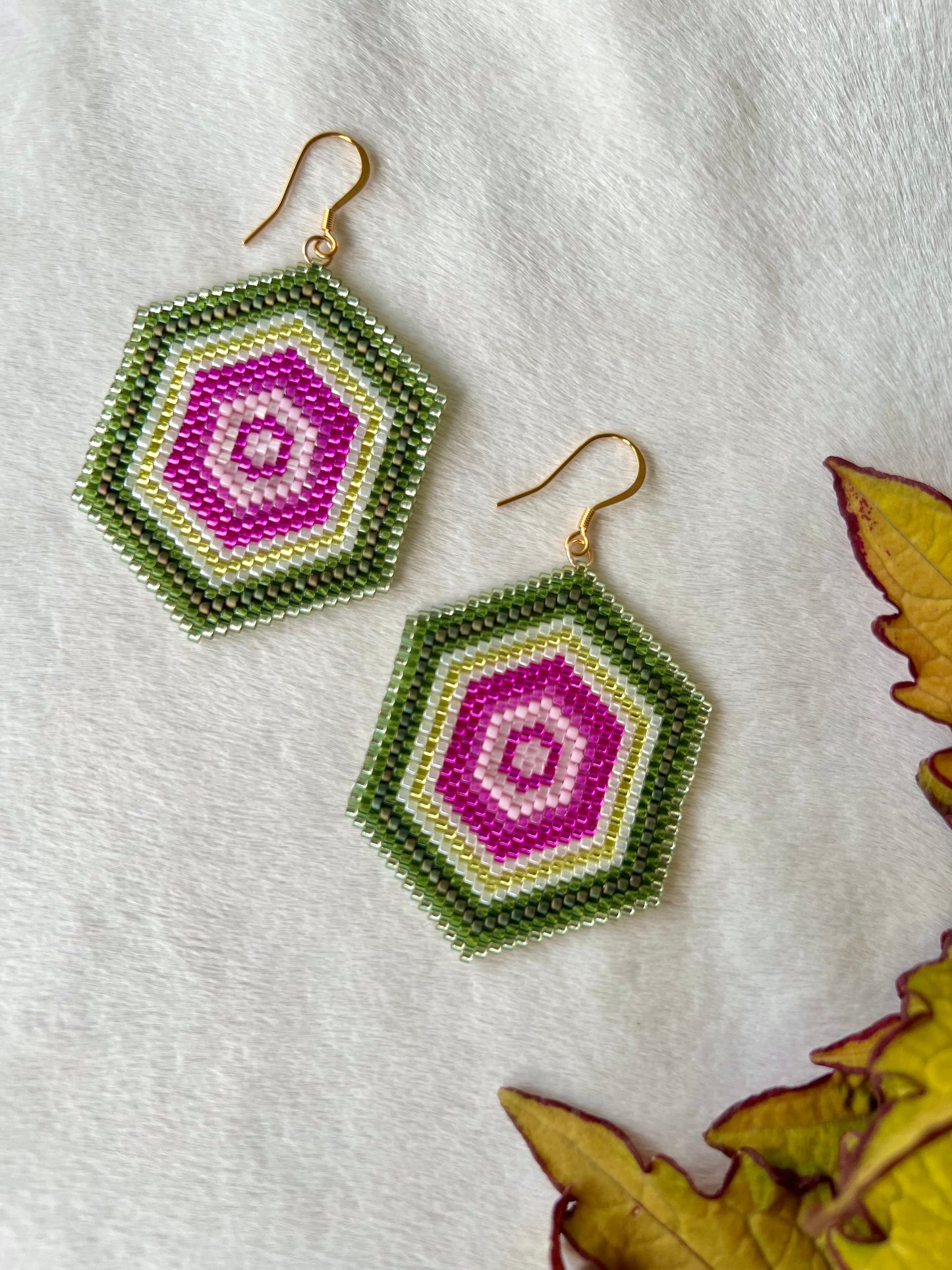 Pink and green hand beaded brick stitch earrings inspired by watermelon tourmaline slices with gold plated earring hooks.