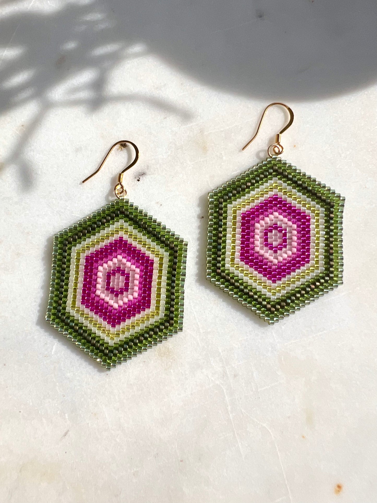 Hand beaded geometric hexagon shaped earrings inspired by vibrant watermelon tourmaline.