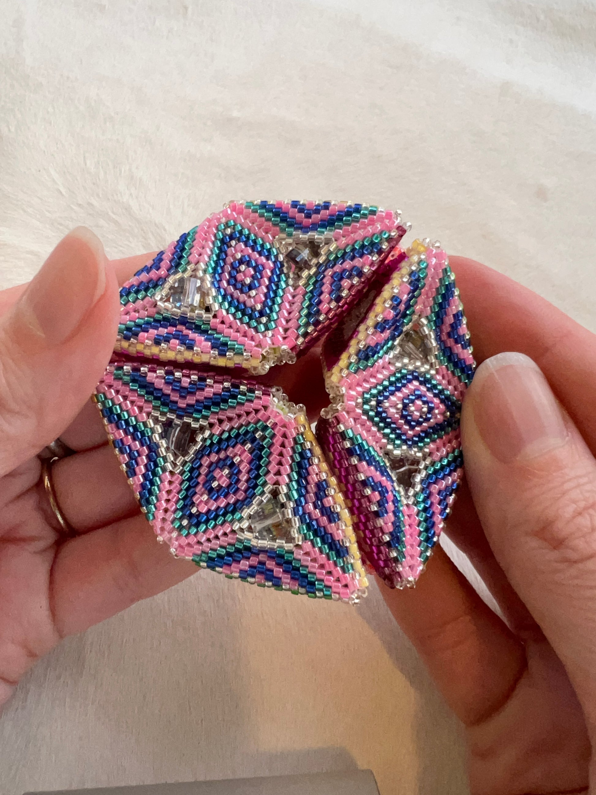 Hand beaded geometric beadwork Kaleidocycle made by Hart + Spade.