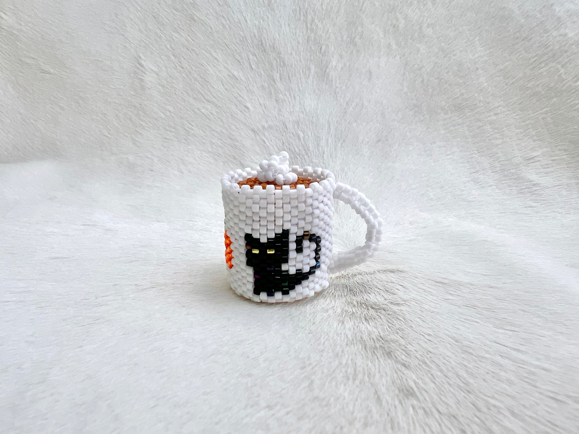 Pixelated mug with a cat design on a white fur background