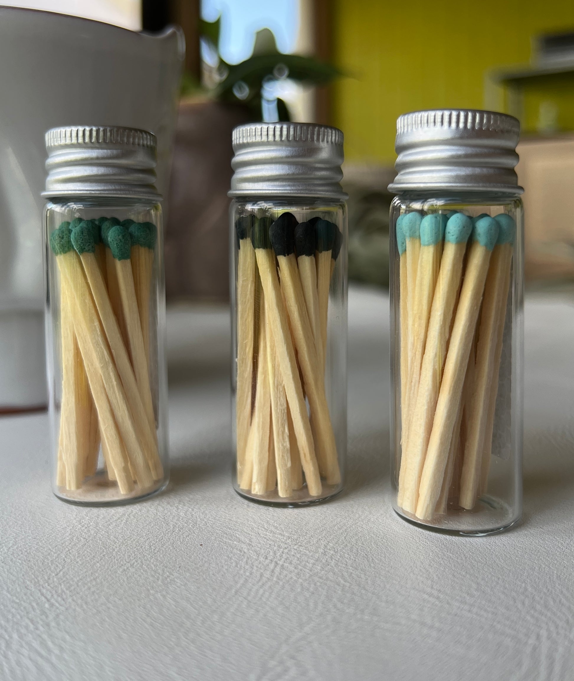 Colorful matches displayed in glass jars.